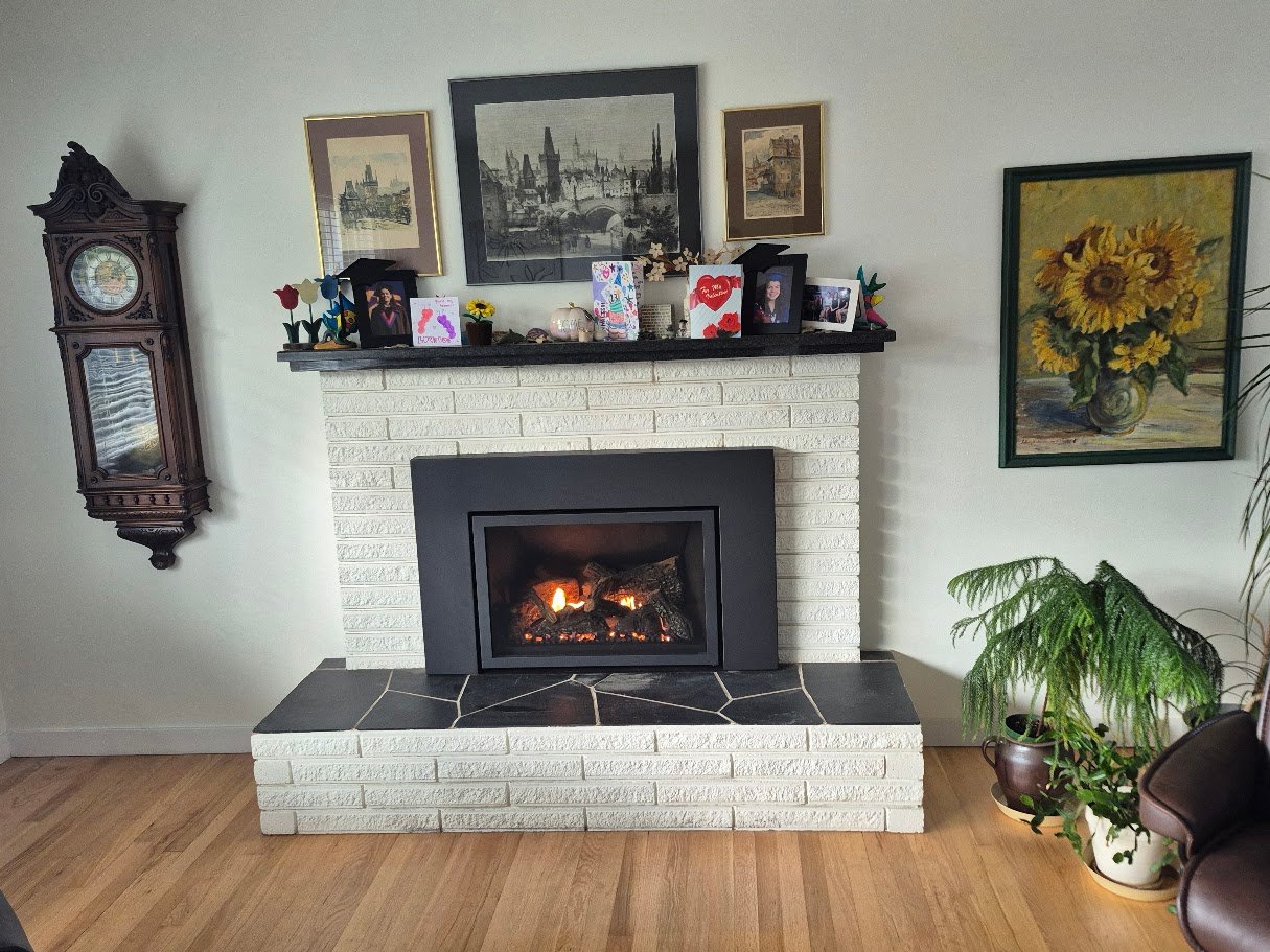 Gas fireplace insert burning in a customer's living room