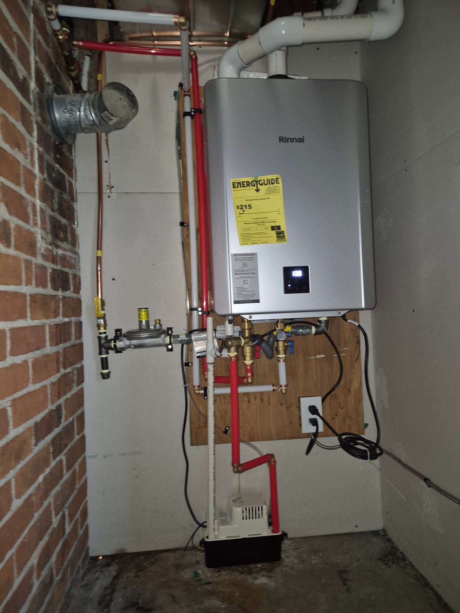 Tankless on-demand water heater installed in a mechanical closet