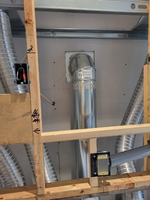 Fireplace vent pipe rough-in through a wall stud bay