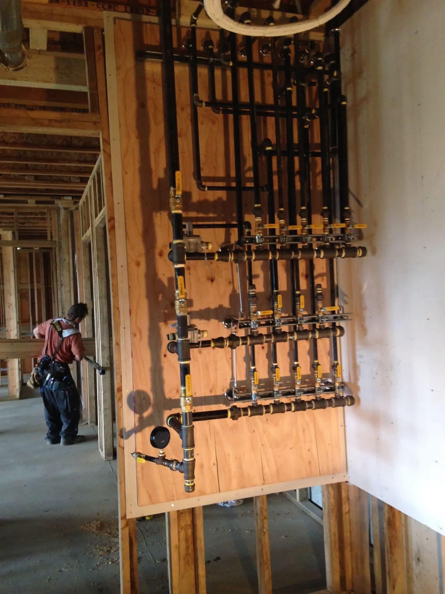 Gas line rough-in with copper piping installed along a ceiling joist